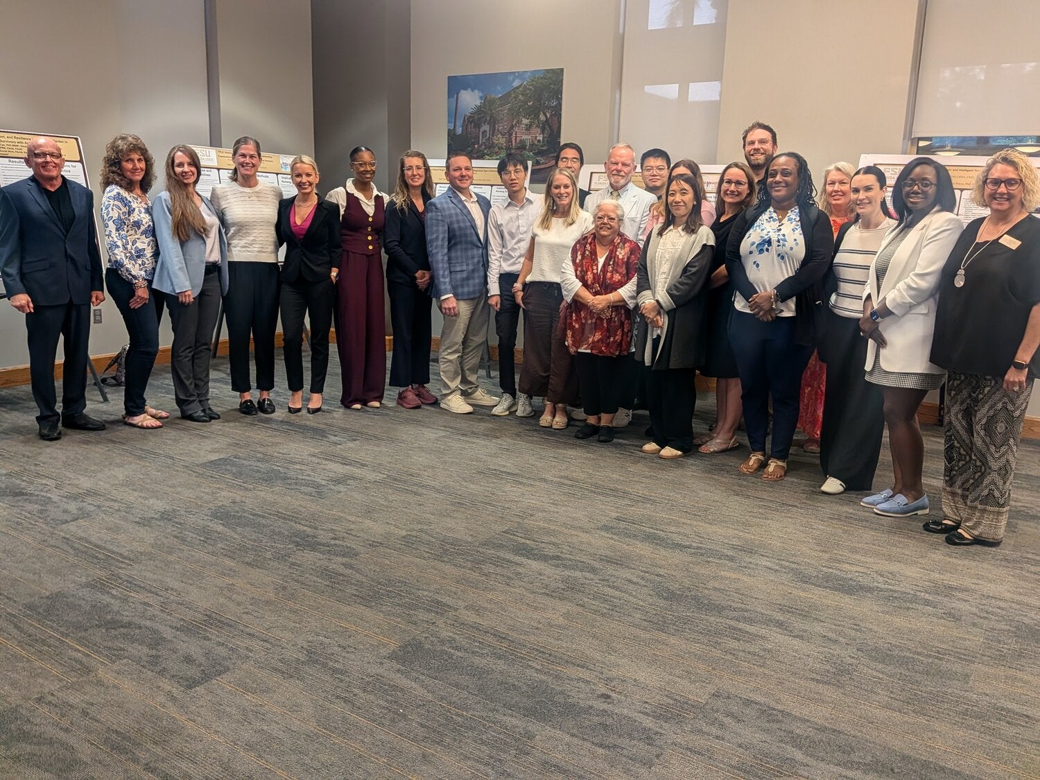 A large number of researchers stand together and pose for a photo